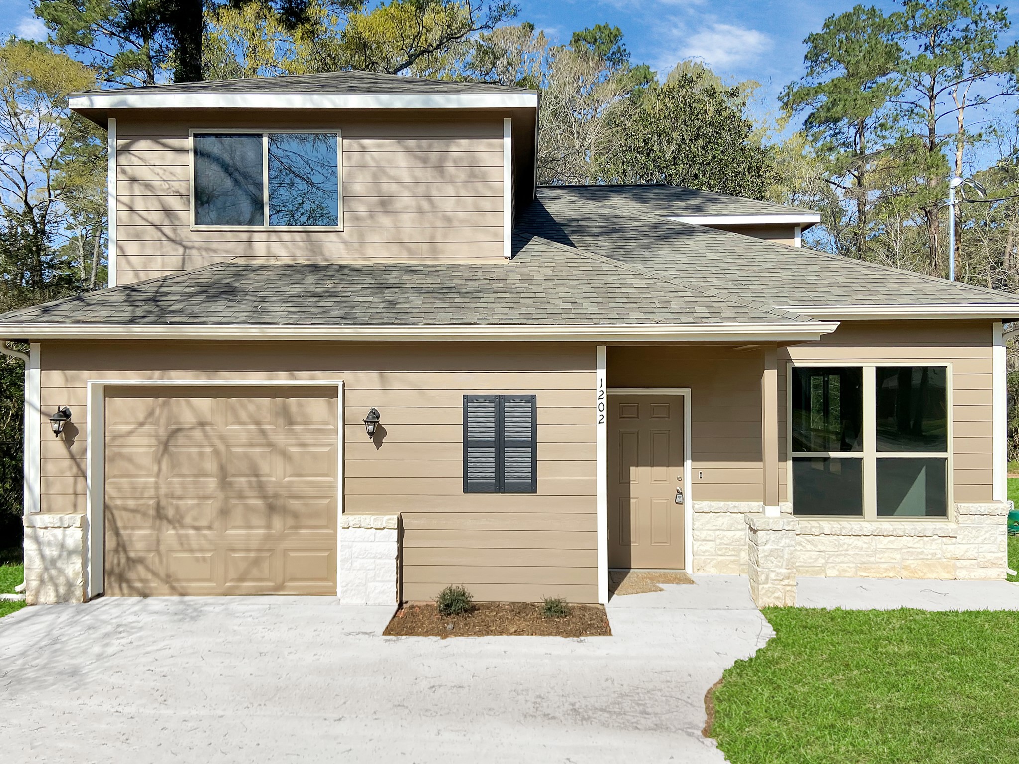 a front view of a house with a yard and garage
