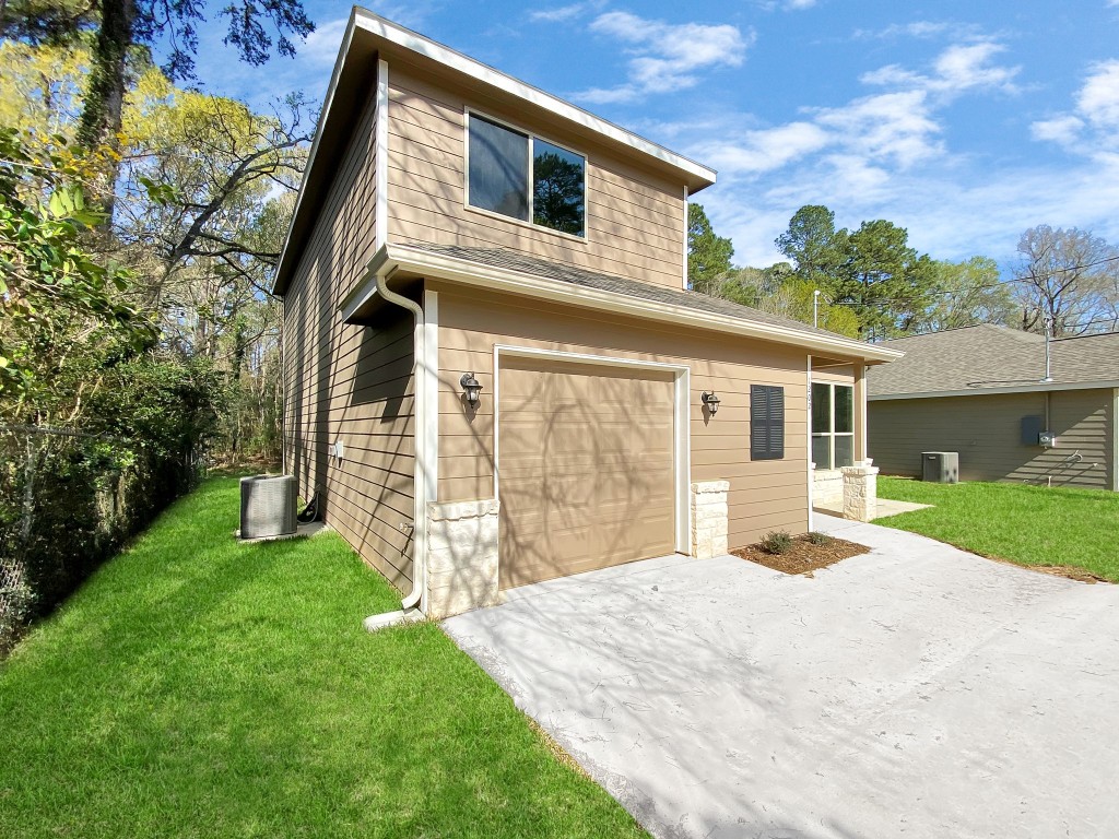 1202 St Lawrence River Road Montgomery, TX 77316 - Photo 3 of 21 a front view of a house with a yard and garage