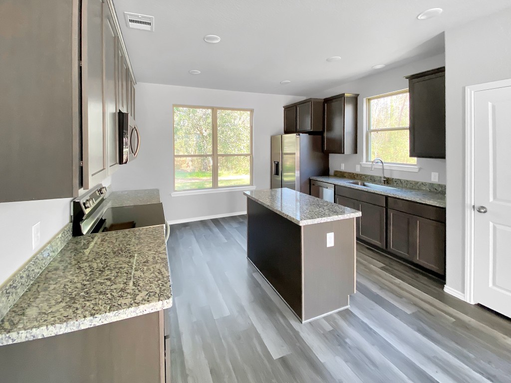1202 St Lawrence River Road Montgomery, TX 77316 - Photo 6 of 21 a kitchen with a sink stove and refrigerator