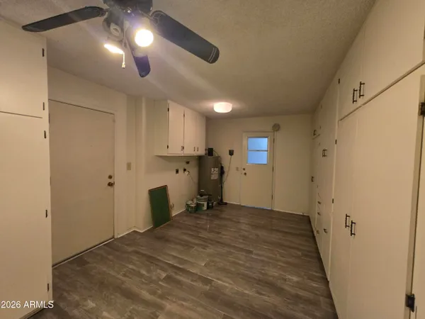 a view of empty room with wooden floor and window