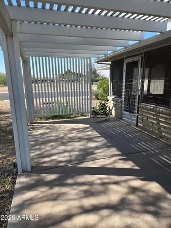 a view of a porch with a table and chairs