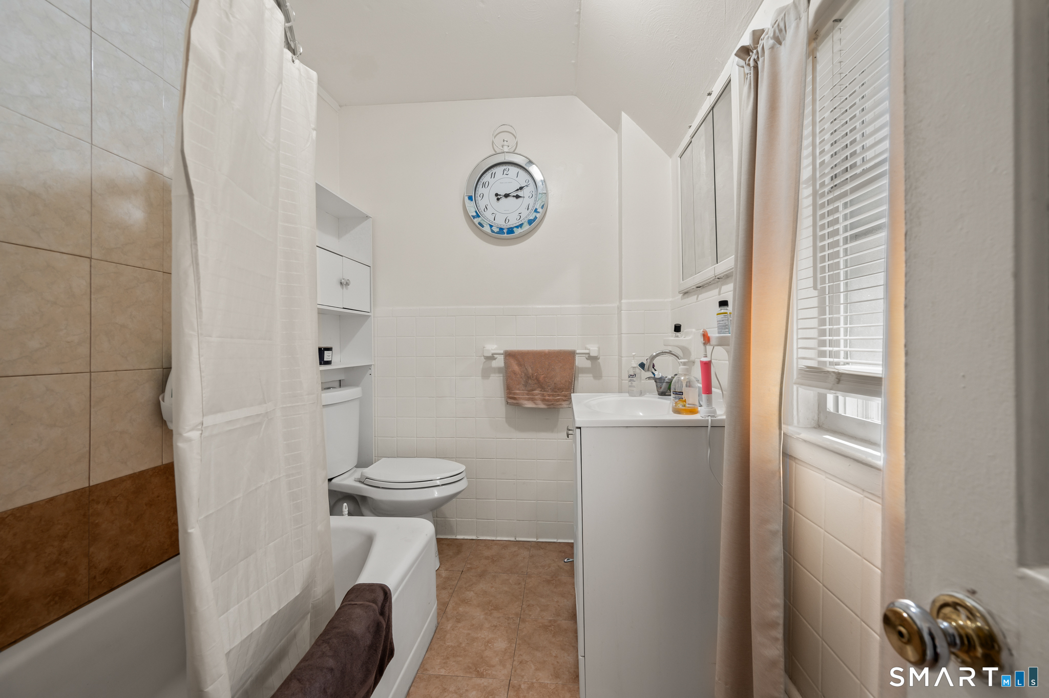 3 Flower Street Middletown, CT 06457 - Photo 13 of 17 a bathroom with a toilet and a shower curtain