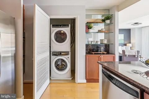 a dining room filled chandelier and kitchen view