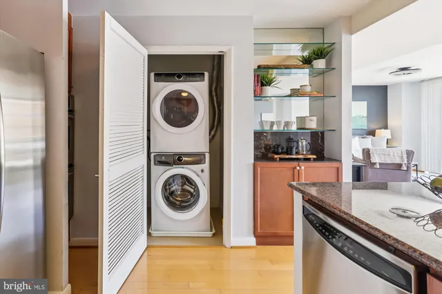 a dining room filled chandelier and kitchen view