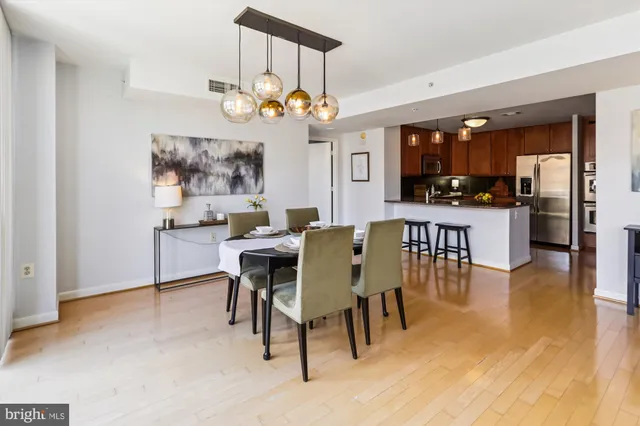 a view of a dining room with furniture and a chandelier