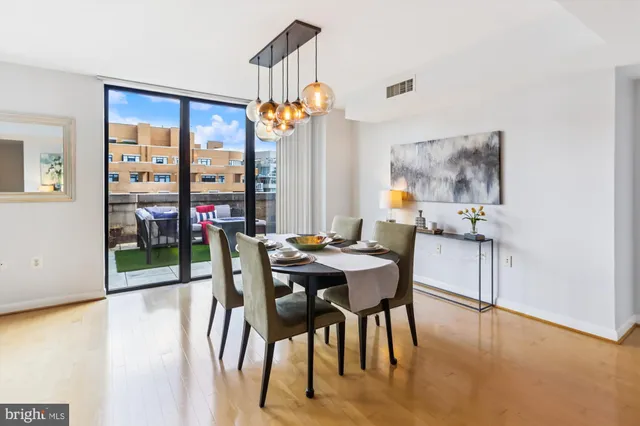 a view of a dining room with furniture window and wooden floor