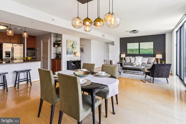 a dining room with furniture window and wooden floor