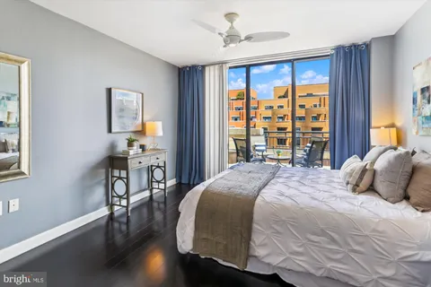 a bedroom with a bed and a dresser next to a window