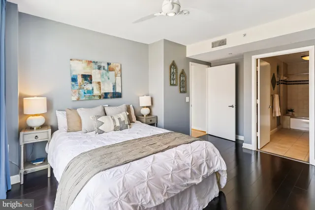a spacious bathroom with a double vanity sink a mirror and a shower