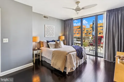 a bedroom with a bed and wooden floor