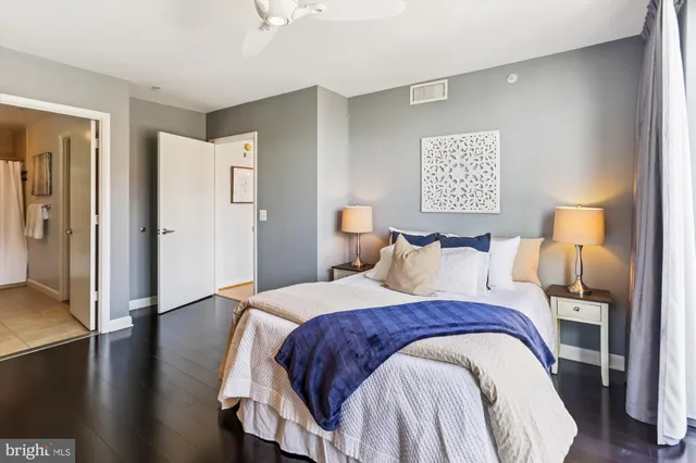 a spacious bathroom with a granite countertop sink mirror and a bathtub