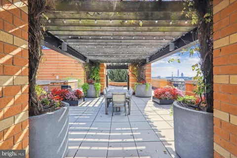 a kitchen with granite countertop a sink cabinets and stainless steel appliances