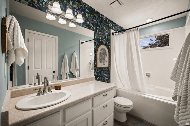 204 Lyman Lane Bountiful, UT 84010 - Photo 11 of 28 Bathroom featuring an oval undermount sink, a light-toned countertop, a full-width vanity mirror, a bathtub with a shower kit, and a window