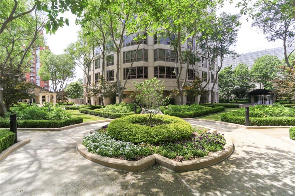 a view of a white house with a yard and potted plants