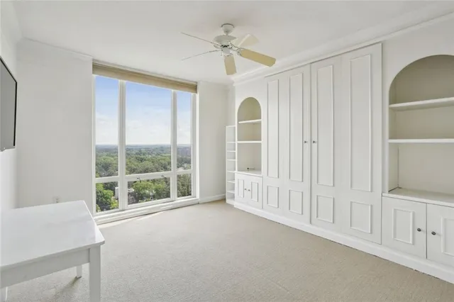 an empty room with windows and closet