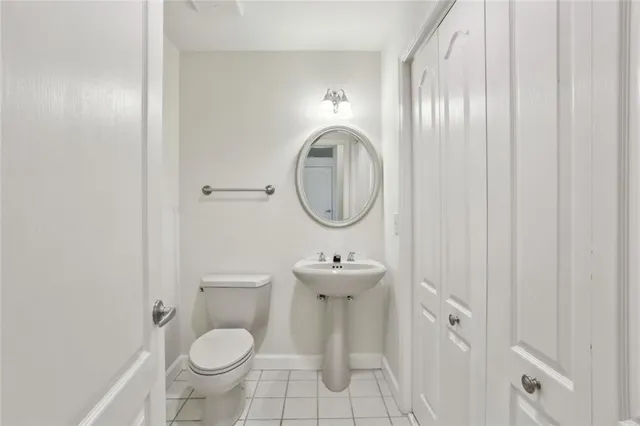 a bathroom with a sink toilet and a mirror