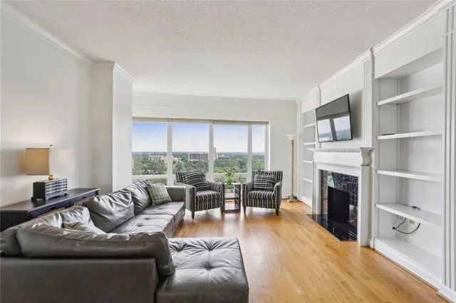 a living room with furniture flat screen tv and a fireplace