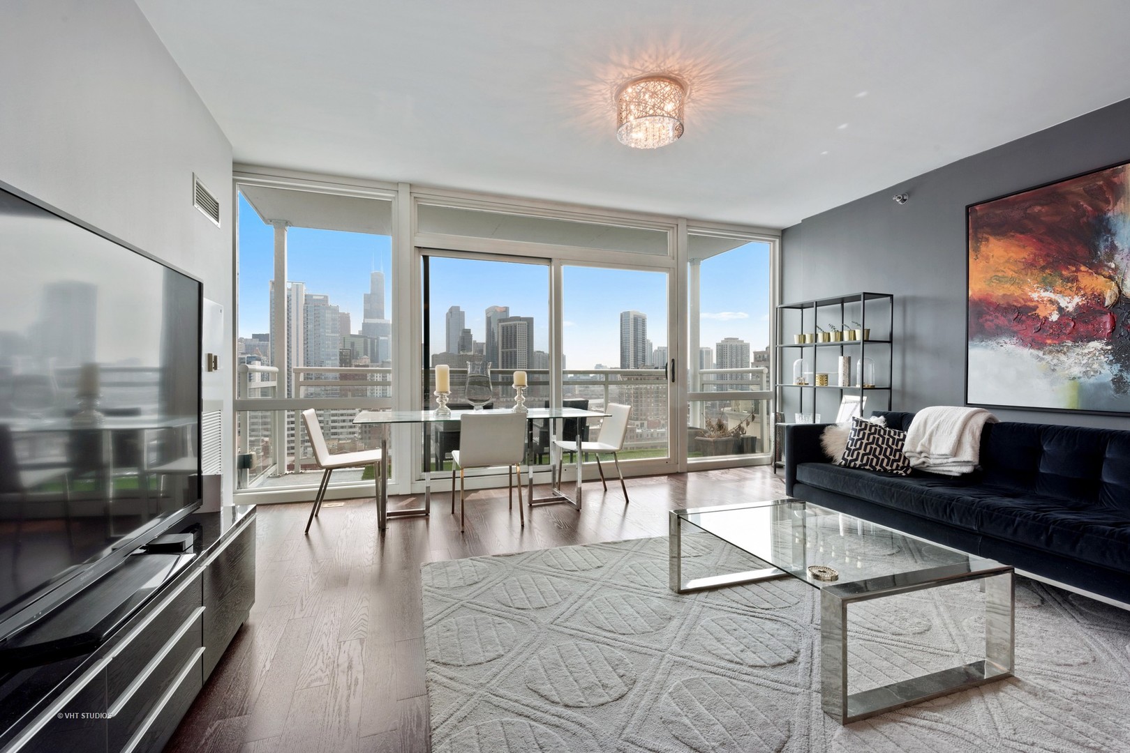 757 North Orleans Street, Unit 1812 Chicago, IL 60654 - Photo 2 of 17 a living room with couches a coffee table and a flat screen tv