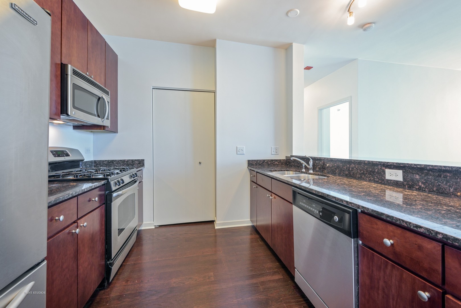757 North Orleans Street, Unit 1812 Chicago, IL 60654 - Photo 5 of 17 a kitchen with stainless steel appliances granite countertop a stove and a sink