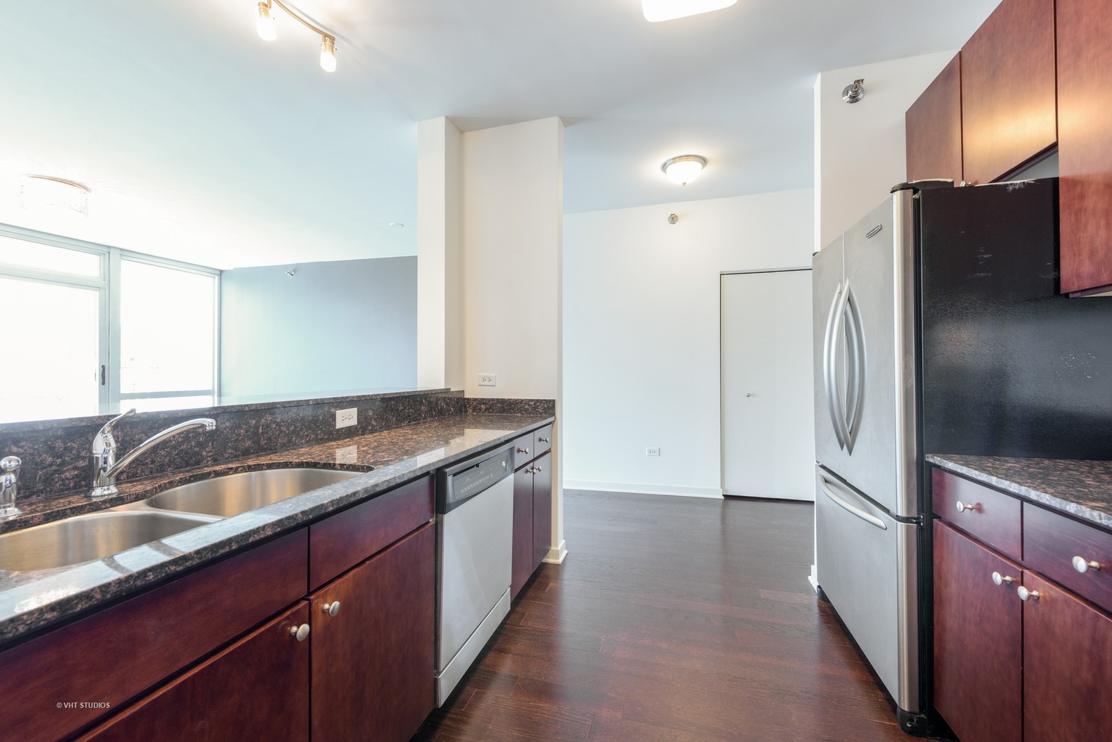 757 North Orleans Street, Unit 1812 Chicago, IL 60654 - Photo 6 of 17 a kitchen with stainless steel appliances granite countertop a refrigerator and a sink