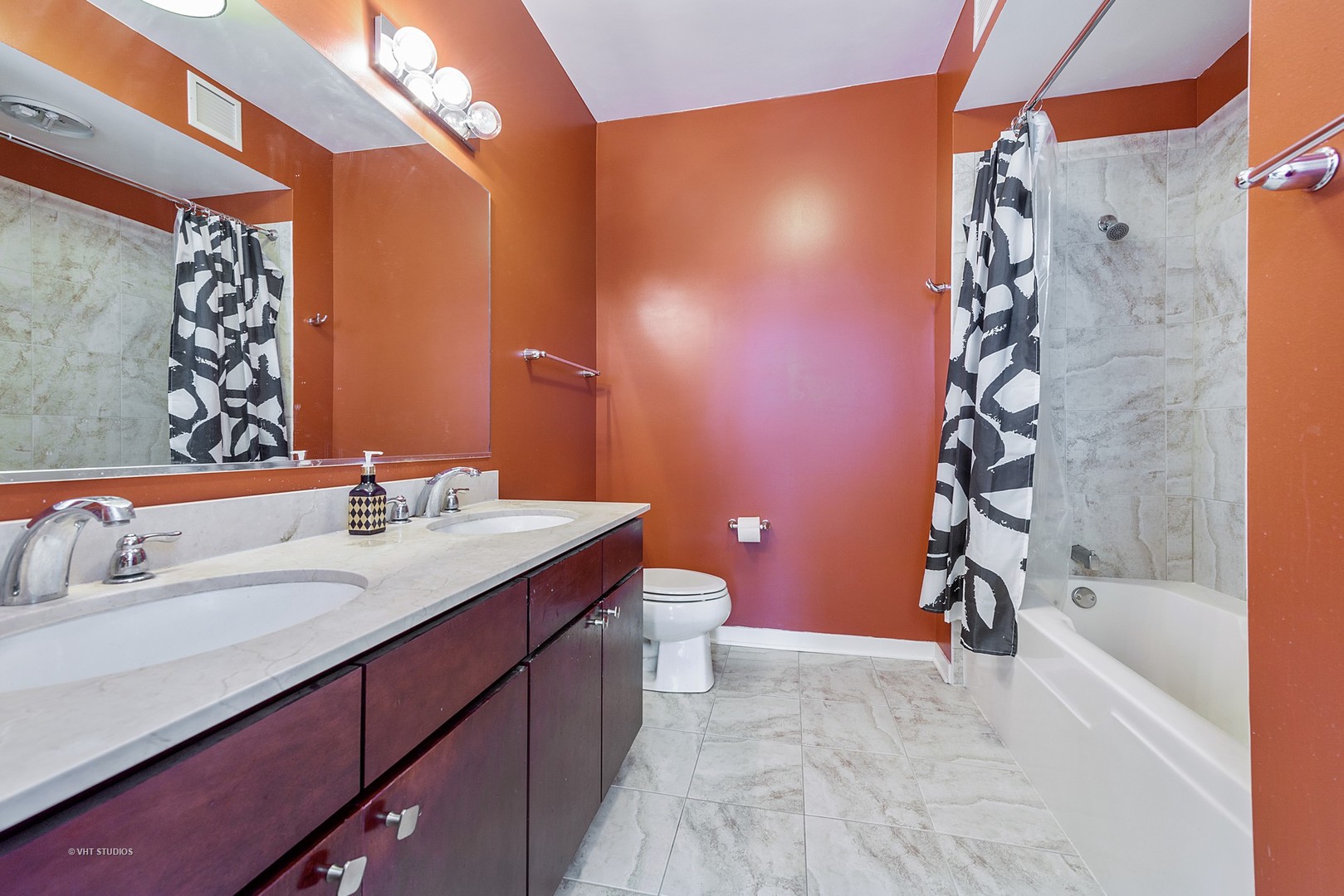 757 North Orleans Street, Unit 1812 Chicago, IL 60654 - Photo 9 of 17 a bathroom with a granite countertop sink a toilet and shower