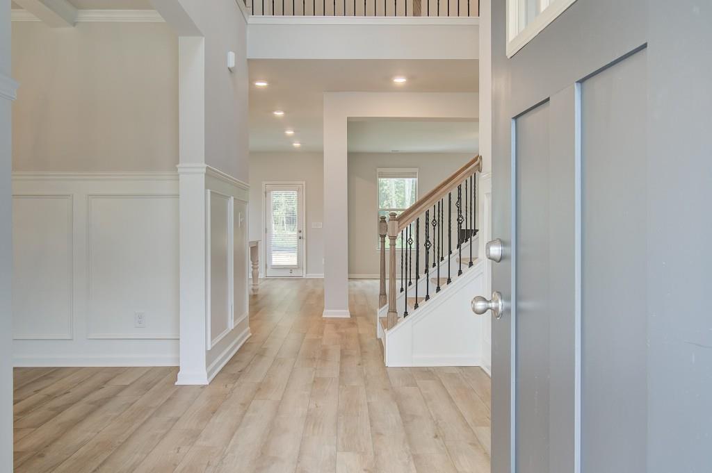 624 Sidney Court Stockbridge, GA 30281 - Photo 2 of 29 a view of a hallway with wooden floor and staircase
