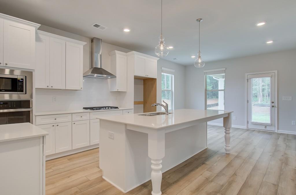 624 Sidney Court Stockbridge, GA 30281 - Photo 6 of 29 a large kitchen with stainless steel appliances kitchen island a large island in the center