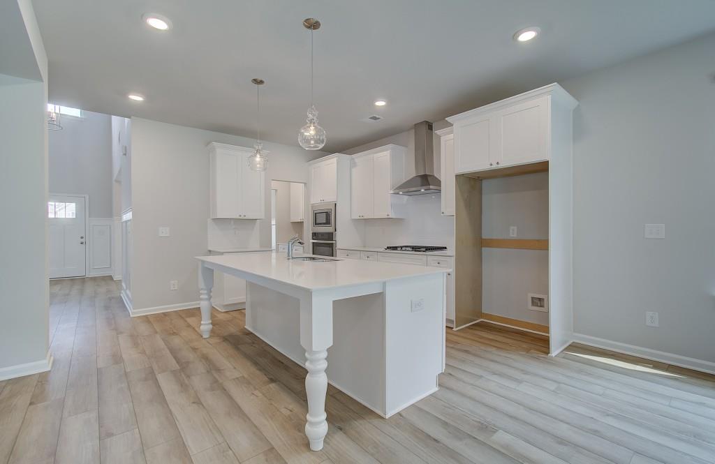 624 Sidney Court Stockbridge, GA 30281 - Photo 9 of 29 a kitchen with white cabinets and wooden floor