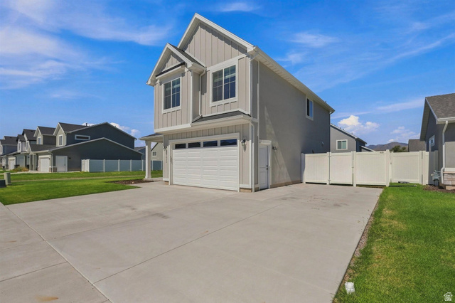 355 West 3085 South Logan, UT 84321 - Photo 3 of 40 Two-story residence featuring light gray siding, white trim, a two-car garage, and a concrete driveway