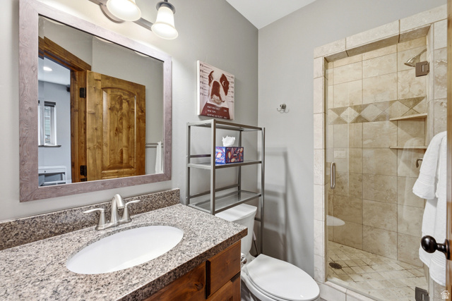 3148 Lower Saddleback Road Park City, UT 84098 - Photo 51 of 67 Bathroom featuring a wood-finish vanity with granite countertop, an undermount sink, and a framed mirror