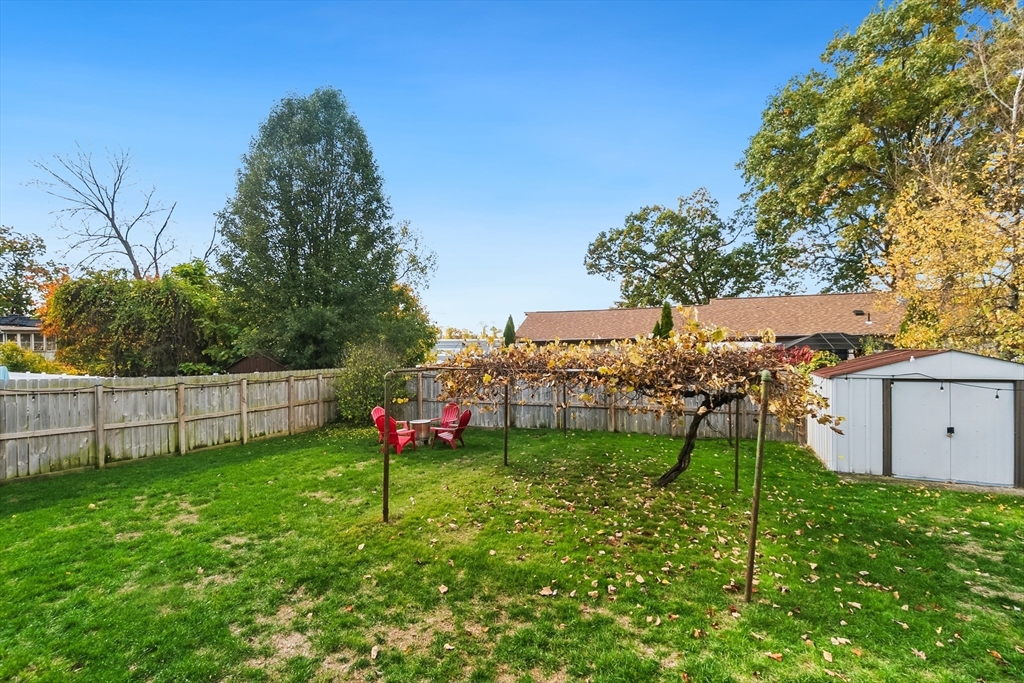 70 Nagle Street Springfield, MA 01151 - Photo 21 of 23 a view of a backyard with a garden and fire pit