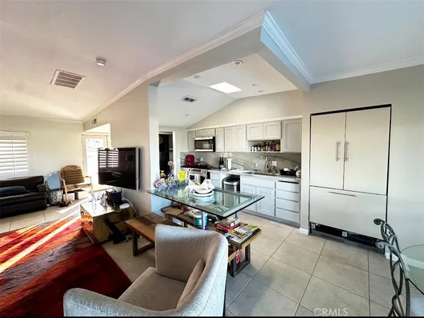 a living room with furniture a flat screen tv and a window