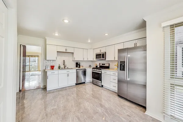a kitchen with refrigerator a sink and cabinets