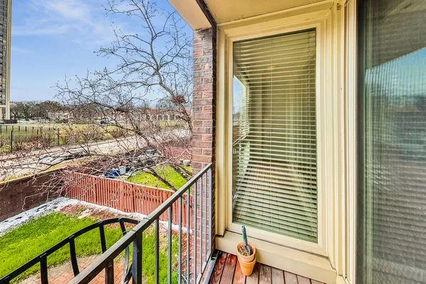 a view of a balcony and trees
