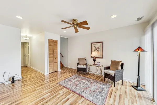 a living room with furniture and wooden floor