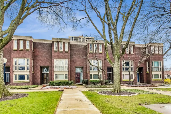 a front view of a residential apartment building with a yard