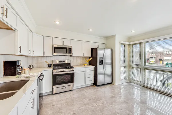 a kitchen with a stove a sink and a refrigerator