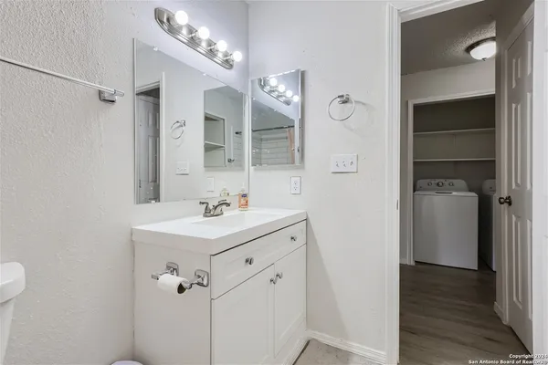 a bathroom with a sink a mirror and a shower