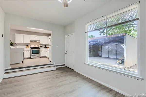 a view of open kitchen with wooden floor and outdoor space