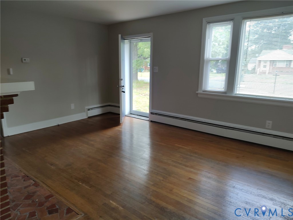 5310 Raleigh Road Henrico, VA 23231 - Photo 5 of 15 an empty room with wooden floor and windows