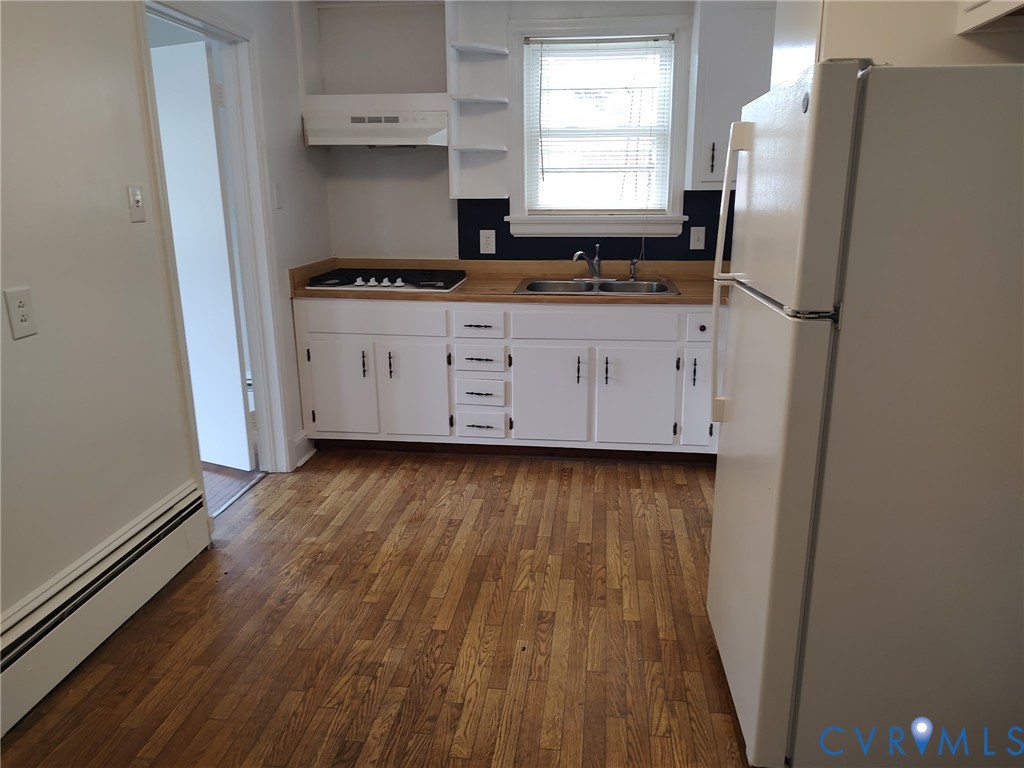 5310 Raleigh Road Henrico, VA 23231 - Photo 8 of 15 a kitchen with granite countertop a refrigerator a sink and wooden floors