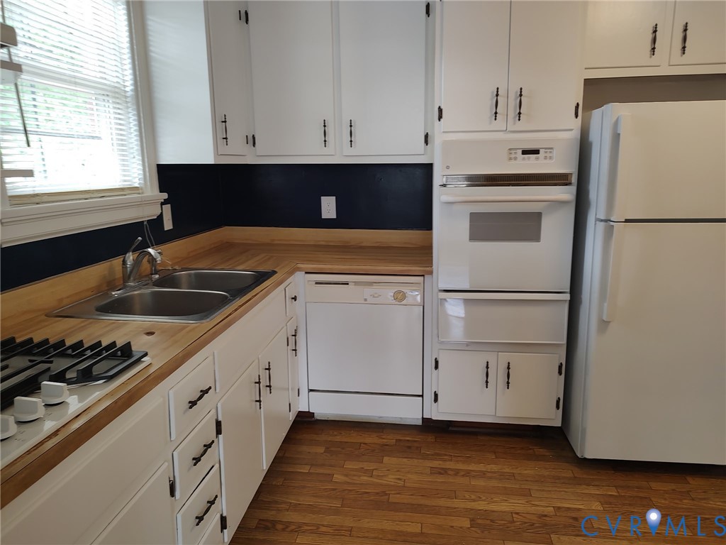 5310 Raleigh Road Henrico, VA 23231 - Photo 9 of 15 a kitchen with granite countertop white cabinets and white appliances