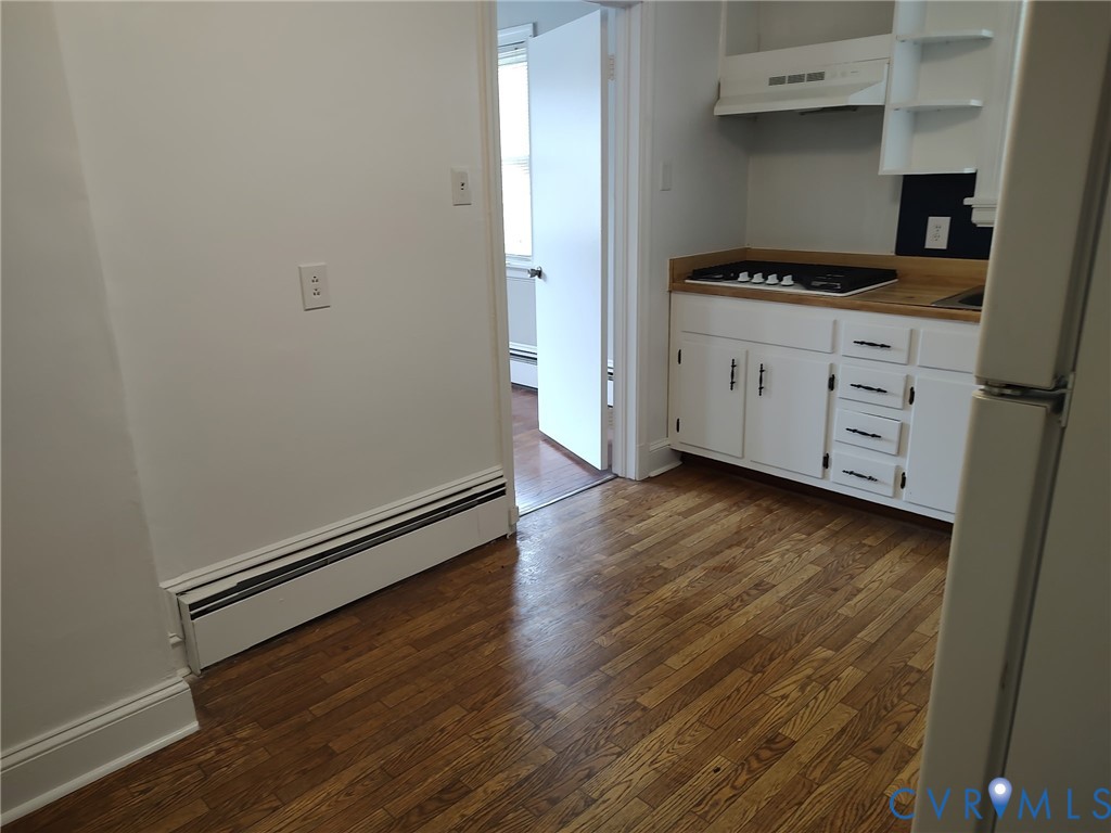 5310 Raleigh Road Henrico, VA 23231 - Photo 10 of 15 a kitchen with granite countertop a stove and a wooden floors