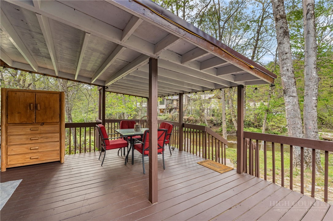 139 Golden Rod Loop Newland, NC 28657 - Photo 30 of 39 a view of a patio with wooden floor and outdoor seating