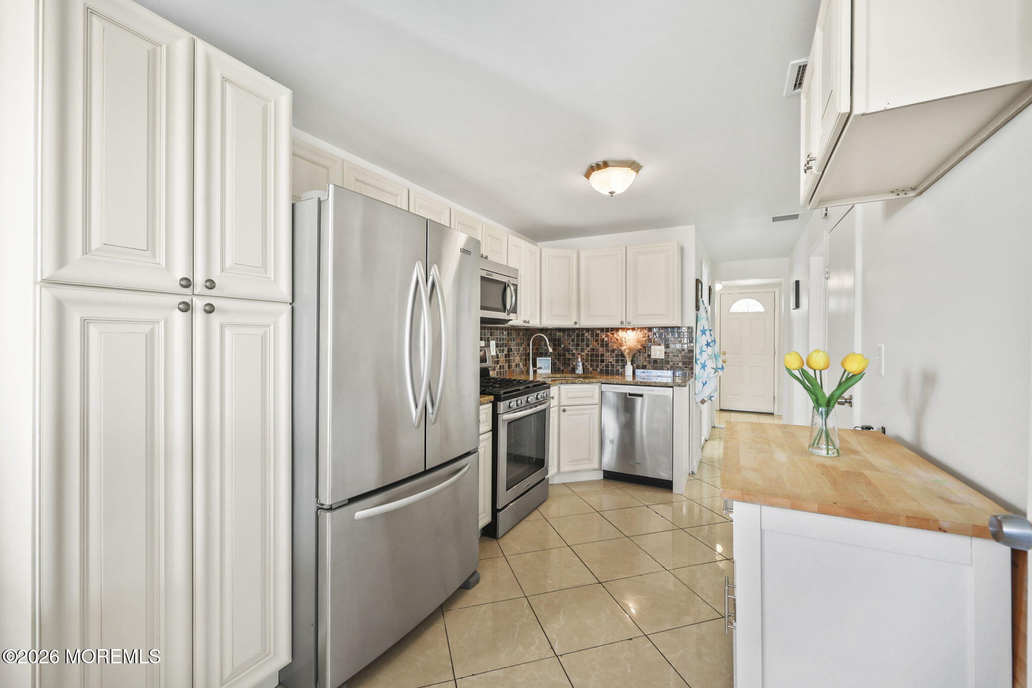 211 Ocean Avenue Point Pleasant Beach, NJ 08742 - Photo 18 of 60 a kitchen with a refrigerator a stove a washer dryer and sink