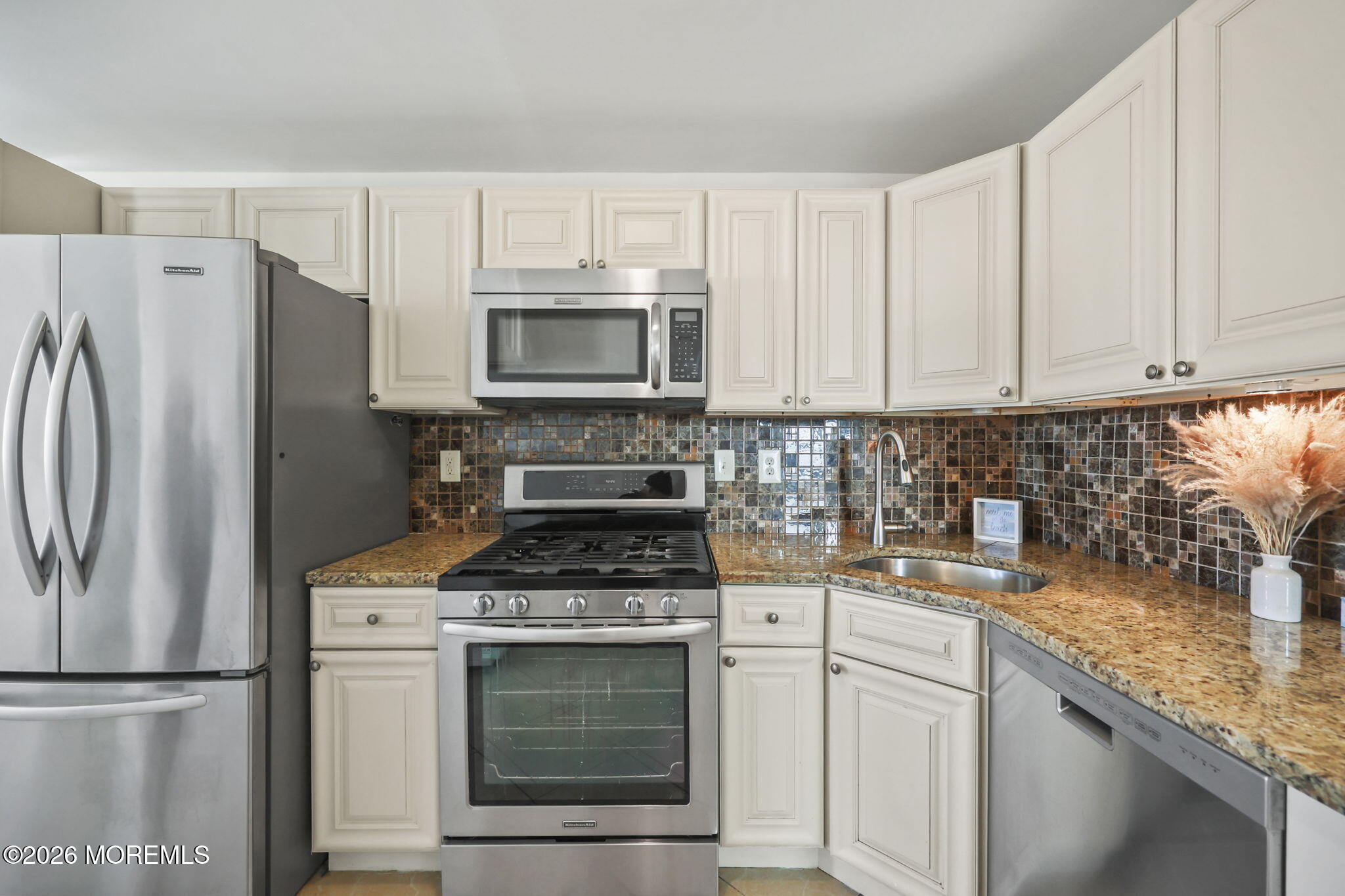 211 Ocean Avenue Point Pleasant Beach, NJ 08742 - Photo 19 of 60 a kitchen with cabinets stainless steel appliances and a counter space