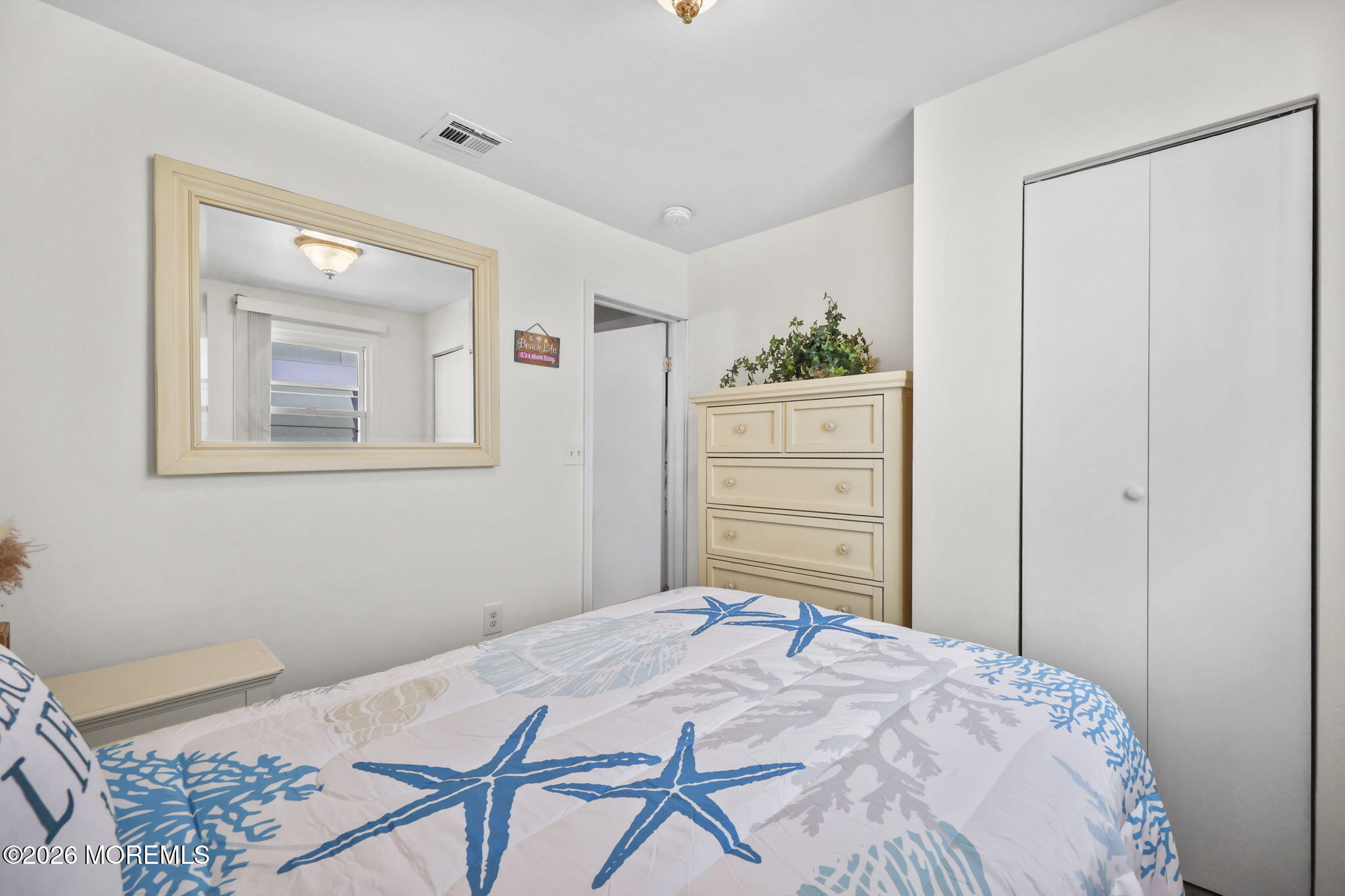 211 Ocean Avenue Point Pleasant Beach, NJ 08742 - Photo 24 of 60 a bedroom with a bed and a dresser in it