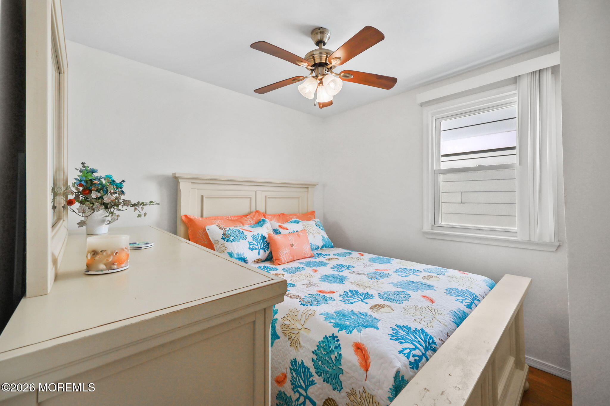 211 Ocean Avenue Point Pleasant Beach, NJ 08742 - Photo 25 of 60 a bedroom with a bed and a chandelier