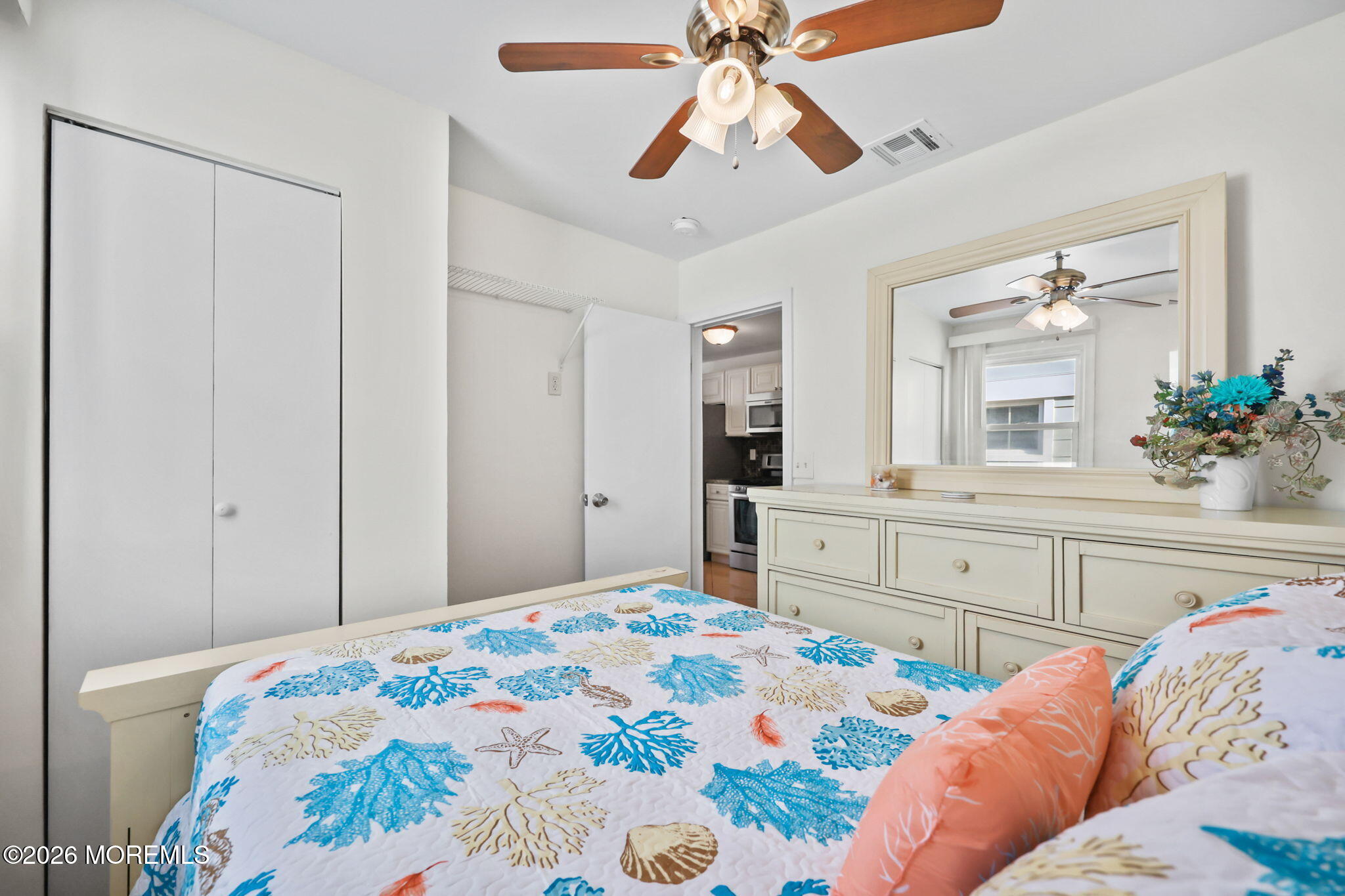 211 Ocean Avenue Point Pleasant Beach, NJ 08742 - Photo 26 of 60 a bedroom with a bed and a chandelier