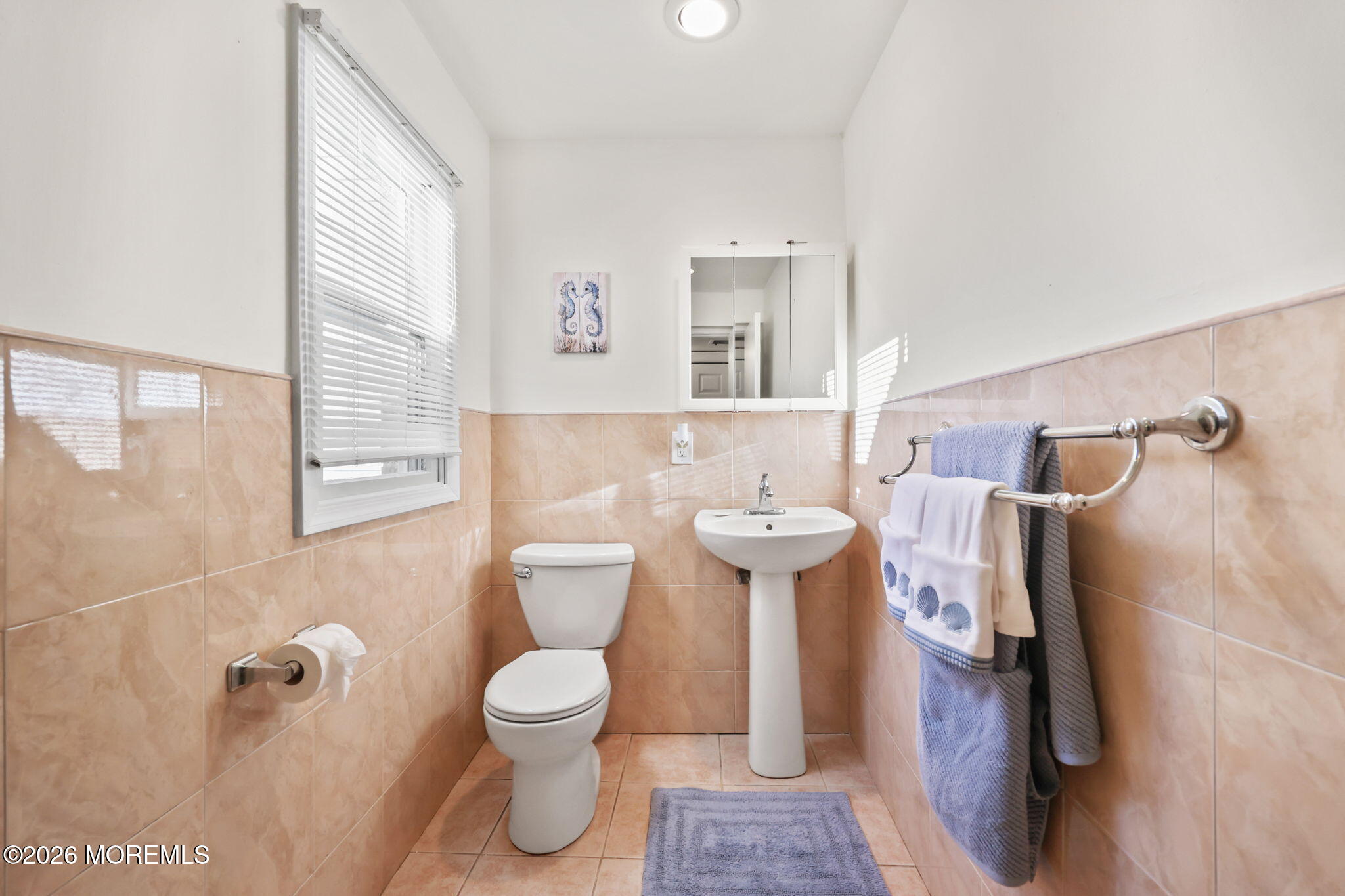 211 Ocean Avenue Point Pleasant Beach, NJ 08742 - Photo 30 of 60 a bathroom with a toilet sink and mirror